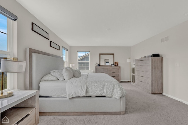 bedroom featuring light carpet