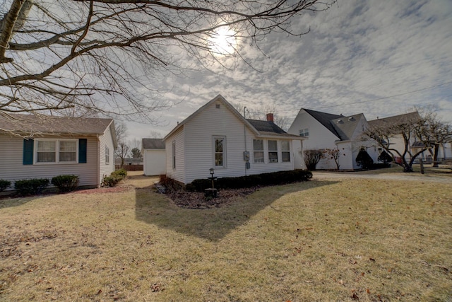 exterior space featuring a yard and a chimney