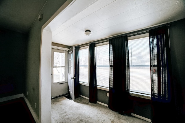 empty room with carpet and baseboards