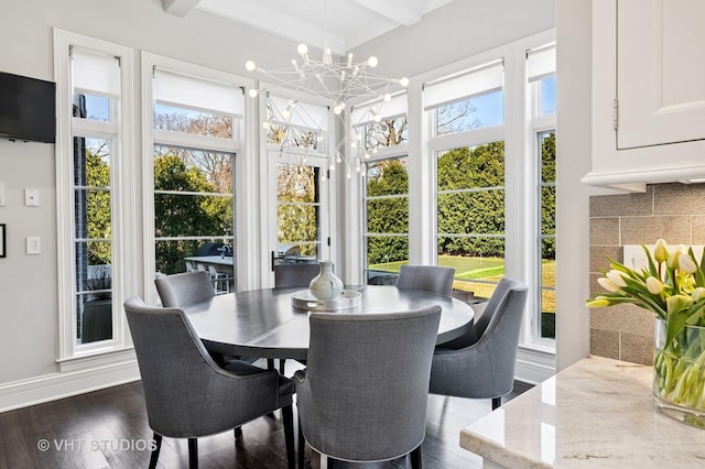 sunroom with beamed ceiling and an inviting chandelier