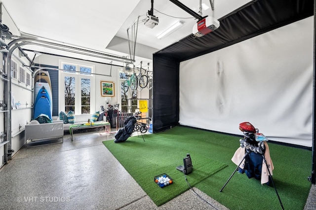recreation room with speckled floor and golf simulator