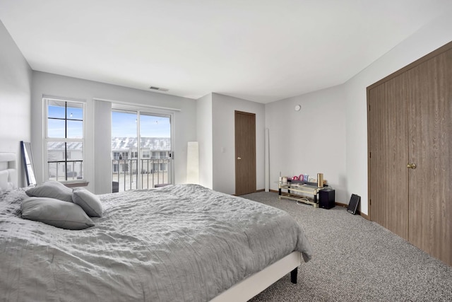 bedroom with baseboards, access to outside, visible vents, and carpet flooring