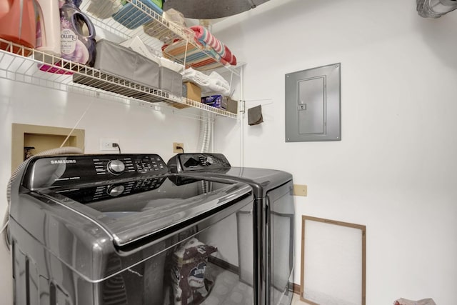 laundry room featuring laundry area, electric panel, and separate washer and dryer