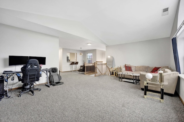 carpeted office featuring visible vents, vaulted ceiling, and baseboards