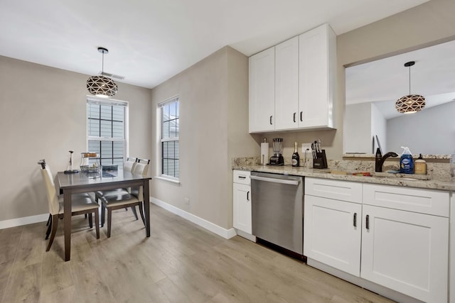 kitchen with stainless steel dishwasher, light stone countertops, white cabinets, and pendant lighting