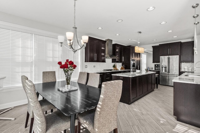 dining space with wood tiled floor, a notable chandelier, baseboards, and recessed lighting