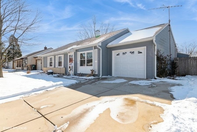 single story home with a garage, concrete driveway, and fence