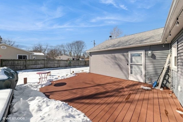 snow covered deck with fence