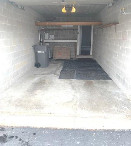 garage with concrete block wall