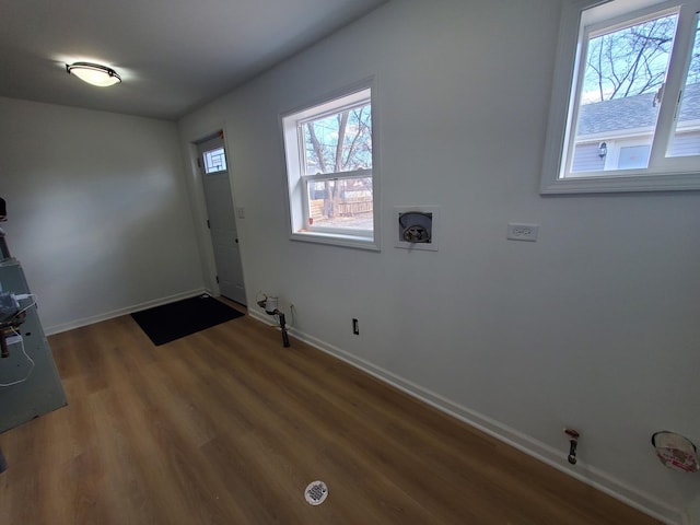 foyer entrance with wood finished floors and baseboards