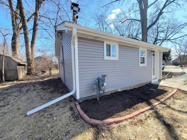 view of home's exterior featuring fence