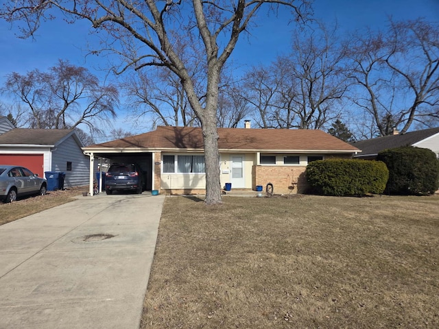 ranch-style house featuring a front yard, driveway, a chimney, a carport, and brick siding