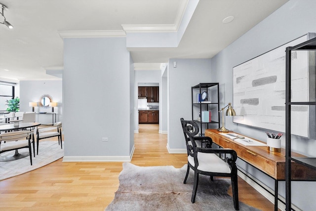 office space with baseboards, wood finished floors, and crown molding