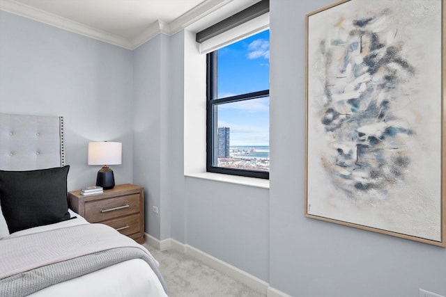 bedroom with carpet floors, baseboards, and crown molding