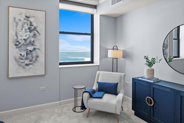 living area featuring carpet, visible vents, and baseboards