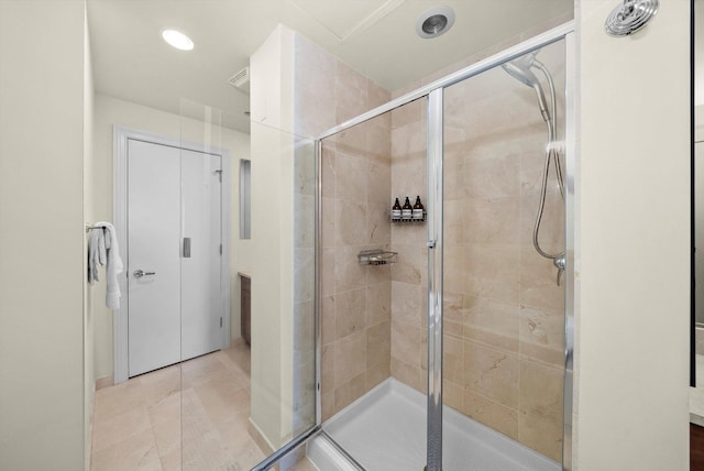 bathroom with a stall shower, visible vents, and recessed lighting