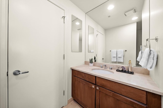 bathroom featuring recessed lighting, visible vents, and vanity