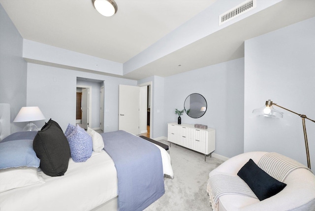 bedroom featuring baseboards, visible vents, and light colored carpet