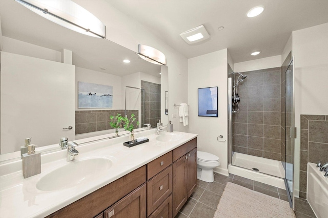 bathroom featuring tile patterned floors, a sink, and tiled shower