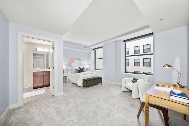 bedroom featuring light colored carpet, ensuite bath, visible vents, and baseboards