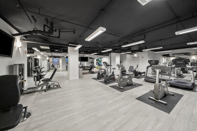 workout area with wood finished floors