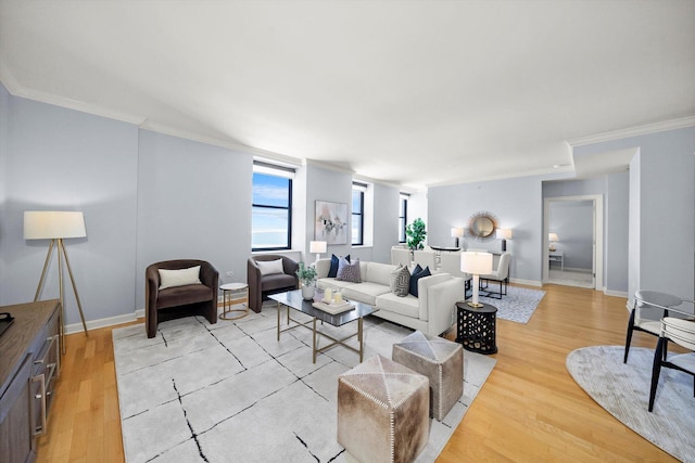 living room featuring crown molding, light wood-style flooring, and baseboards