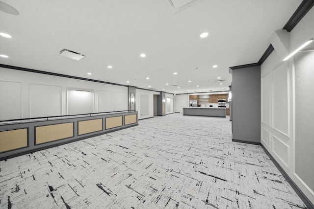 unfurnished room featuring visible vents, ornamental molding, a decorative wall, and recessed lighting