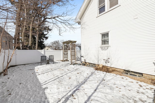 yard covered in snow featuring a fenced backyard