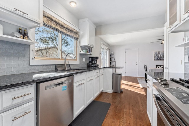 kitchen featuring a sink, white cabinetry, open shelves, and dishwasher