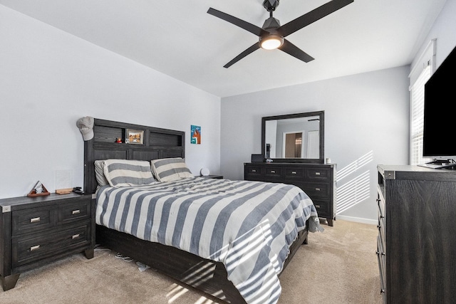 bedroom featuring ceiling fan, baseboards, and light colored carpet