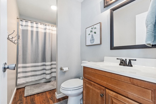 full bathroom with toilet, wood finished floors, vanity, baseboards, and a shower with curtain