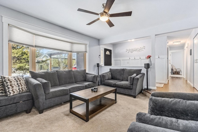 living room with ceiling fan and light wood-style flooring