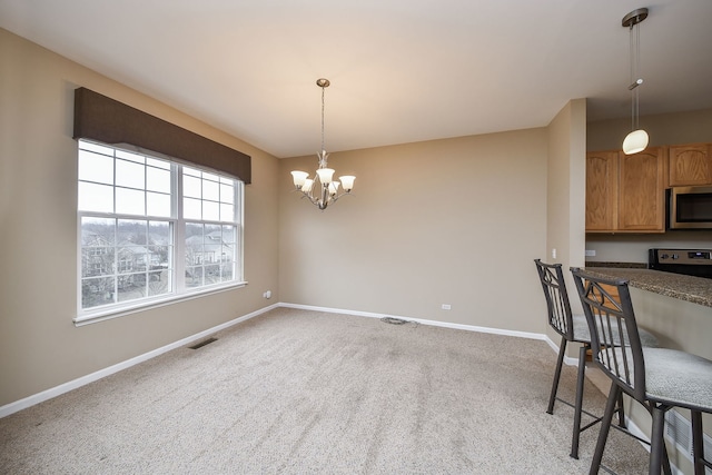 dining room with baseboards, visible vents, a chandelier, and light colored carpet