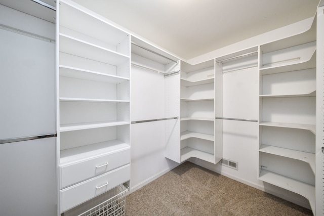 walk in closet featuring carpet flooring and visible vents