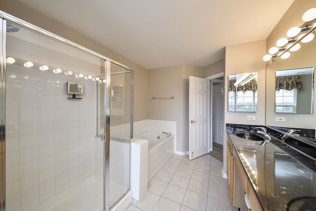 bathroom featuring double vanity, a stall shower, a bath, and tile patterned floors