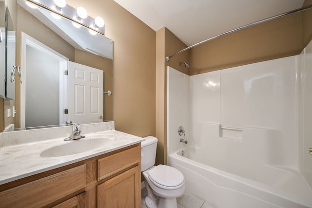 bathroom featuring toilet, vanity, washtub / shower combination, and tile patterned floors