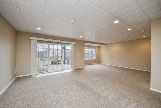 spare room featuring baseboards, carpet flooring, and recessed lighting