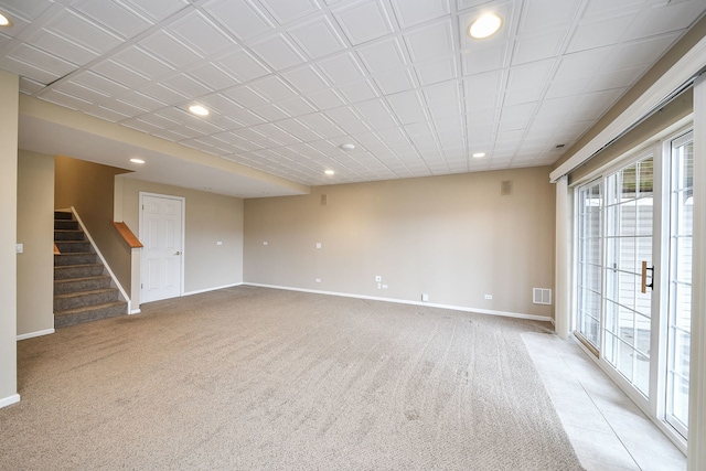 empty room with light carpet, stairway, recessed lighting, and baseboards