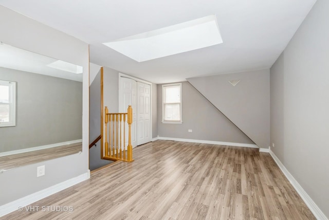 interior space featuring light wood-type flooring and baseboards