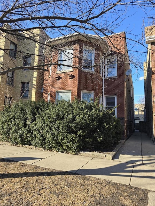 view of side of home featuring brick siding