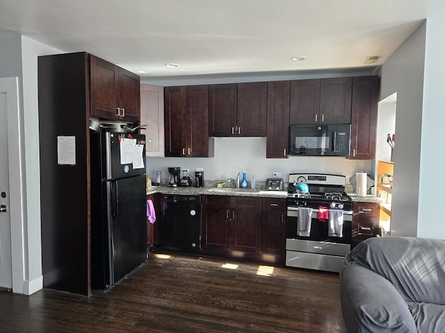 2320 W Addison St, Chicago, IL 60618 - kitchen with light stone counters, dark wood-style flooring, dark brown cabinets, and black appliances