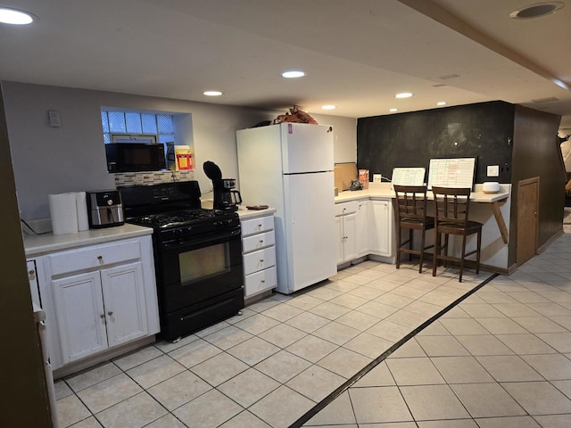 2320 W Addison St, Chicago, IL 60618 - kitchen with light tile patterned floors, recessed lighting, white cabinets, light countertops, and black appliances