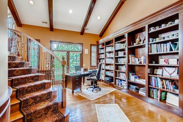 home office featuring light hardwood / wood-style flooring and vaulted ceiling with beams