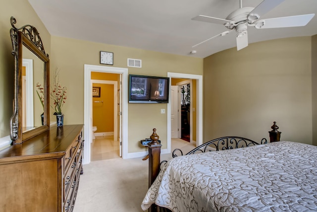 carpeted bedroom featuring ceiling fan and ensuite bath