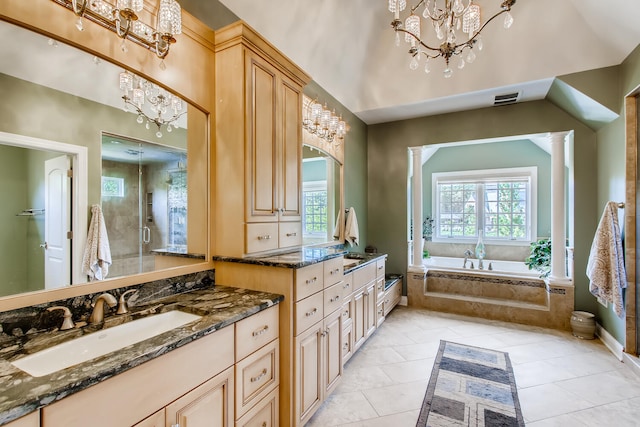 bathroom with ornate columns, a chandelier, independent shower and bath, and tile patterned floors