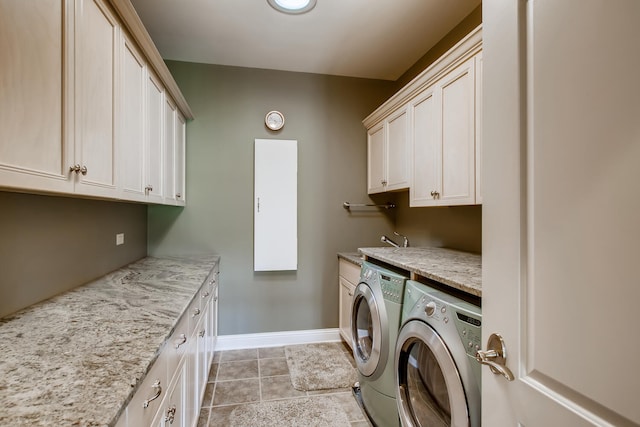 clothes washing area with cabinets, light tile patterned floors, sink, and separate washer and dryer