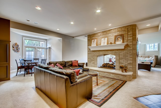 carpeted living room featuring a brick fireplace