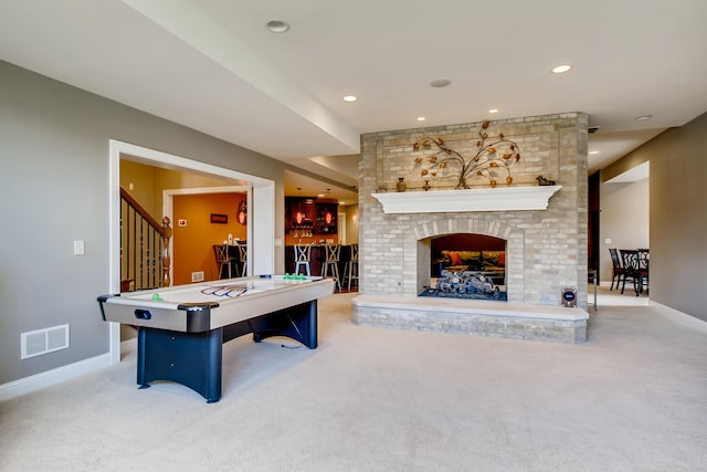 game room featuring pool table, indoor bar, light colored carpet, and a fireplace