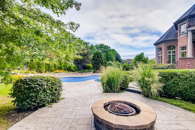 view of patio / terrace featuring an outdoor fire pit