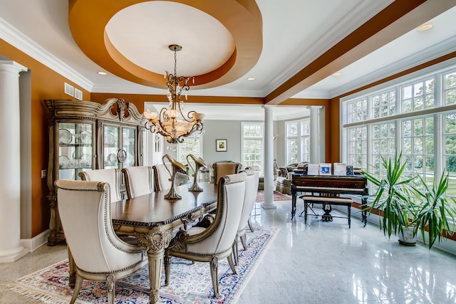 dining area featuring ornamental molding, ornate columns, an inviting chandelier, and a raised ceiling